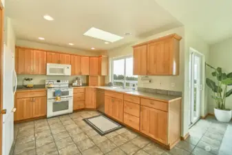 Kitchen has a pantry, fridge, double oven and microwave. Tile floor and skylight!
