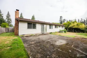 Large fenced in backyard with large patio.