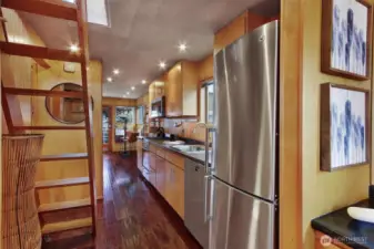 A warm welcome and a fun glimpse to see the water way on the other side of the houseboat.  To the left of this picture are two utility closets.  One is for the on demand hot water heater and new washer and dryer.  The other one is for storage and hanging jackets, shoes, lifejackets etc.