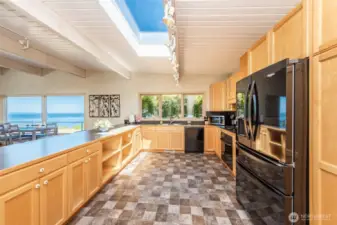 The large, open kitchen has plenty of storage and natural light, and allows the cook to still be part of the conversation in the great room.