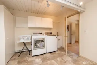Large laundry room with built in cabinets and ample space. New floors. New utility sink. Newer steam washer and dryer.