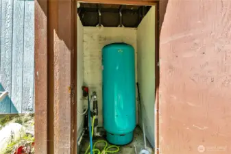 Pump house on the back side of the mobile home.