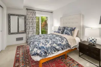 Bedroom located on first floor with sliding glass door access to back patio area.