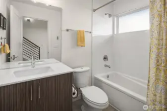 Full bathroom located on first floor equipped with ample storage space.