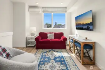 Seating area in living room framed by windows.