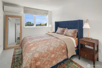 Primary bedroom with large windows.