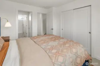 Primary bedroom with sliding door closet in addition to walk in closet.