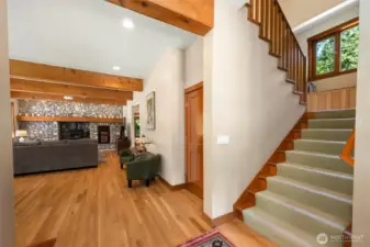 View from entry into main living space.  Wide staircase with window seat.