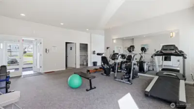 Open layout and bright windows create an inviting fitness environment.