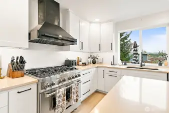 Chef's kitchen features 6-burner gas stove & stunning football views right from the kitchen!