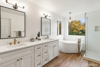 The primary 5 piece bath suite features a free standing soaking tub & elegant gold hardware.