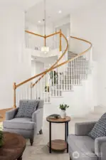 Graceful staircase winds gently above formal Living and Dining areas