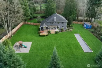 Fully fenced backyard with Bocce Ball Court, Fire Pit, Shed and Play Structure