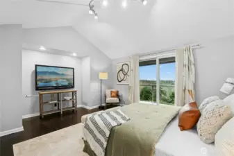 Bedroom (1st Bedroom) on the Main level sports vaulted ceilings and it's own private deck.  (Closet framing has been removed but can easily be replaced). A thoughtful guest bedroom and/or easy access for Multi-generational living.