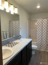 Double sinks and full bath round out this Primary Suite.