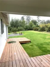 Looking north to the firepit and picnic table.  All compressed gravel beyond the beautiful lawn.