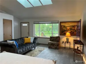 Large living room windows and skylights for lots of light. Coat closet at the entry.