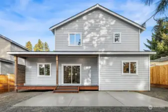 This is a view from the back side of the home. Fabulous covered trex deck area for year around outdoor living plus huge patio space for summertime fun or maybe even an above ground swimming pool!