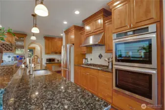 You will enjoy granite slab countertops, stainless steel appliances, a gas cooktop, full tile backsplash, and abundant storage throughout this chef's kitchen.