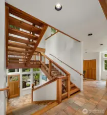 Inside, this magnificent extra wide staircase ascends to 3 levels with wall of glass to capture the landscape.