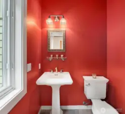The powder room offers Kohler fixtures.