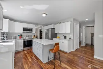 Tastefully done Kitchen has plenty of cabinets & counter  space. Newer ss appliances.