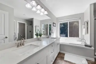 Primary bath with soaking tub looking out to the back private scenery