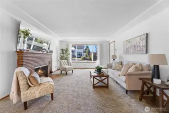 Beautiful, spacious living room with wood fireplace and large picture window