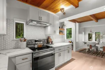 The kitchen shines with a sleek backsplash and warm, earthy character.