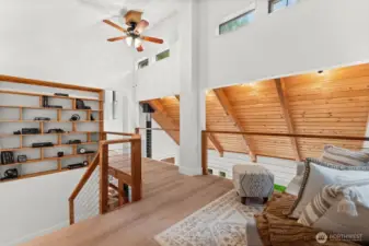 Upstairs, a custom bookcase stretches from top to bottom—both stylish and functional.