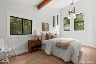 The primary suite radiates energy with its chandelier, unique windows, and thoughtful design.