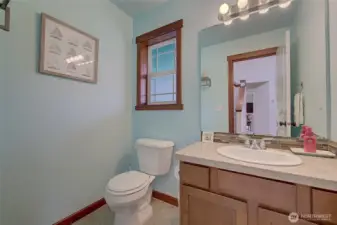 Perfectly placed half bath to the right as you enter, offering convenience for guests while maintaining privacy from the main living and gathering areas.