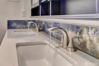 Beautifully refreshed in 2024, the primary bath offers updated finishes, dual sinks, and a spacious design that combines style with everyday convenience.