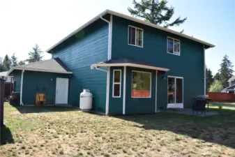 Convenient door from the three-car garage provides easy access to the backyard, making outdoor activities and entertaining a breeze.