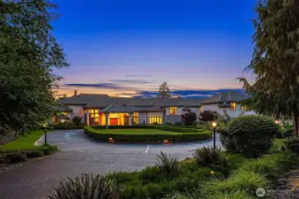 The private, Magnolia lined drive features a gated entry w/ keypad & remote, inground walkway illumination, lampposts and landscaping lighting.