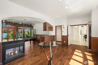 Glass French doors lead to covered patio. Wainscoting wrap the parlor. Bar w/refrigerator & sink.