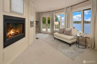 Retreat to the Primary Suite w/sitting area, wet-bar w/fridge, dual-sided gas fireplace, and glass French doors that lead to private verandah.