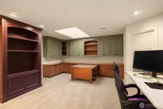 Large loft space with built in desks, bookcase, pull out desk, skylight and spacious adjacent storage closet.