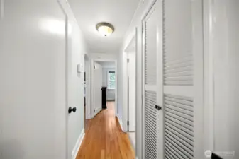 Hallway leading to the full bathroom, second bedroom and primary bedroom.