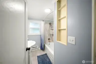 Full bathroom with built in storage.