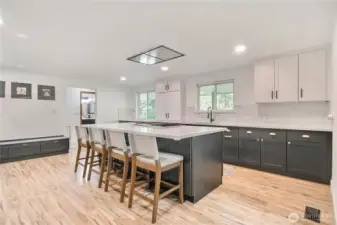 Gorgeous gourmet kitchen with huge quartz island, recessed lighting, tons of natural light an abundance of counterspace and cabinets.