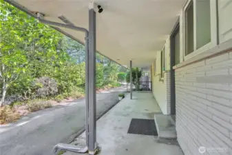 Covered front porch with drive through driveway.
