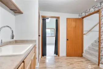Laundry room with staircase to private guest quarters w/ 2 bedrooms, great room & micro kitchen
