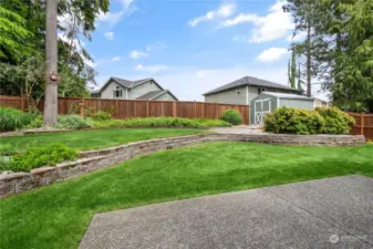 Large fully-fenced lot with lush grass and lots of space for entertaining