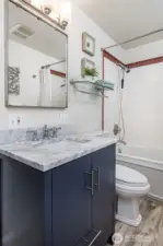 Full bathroom on the main level behind the kitchen.