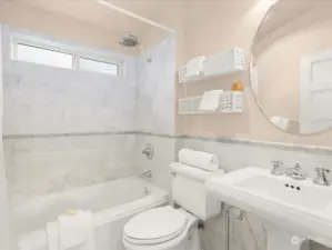 The upstairs full bathroom features marble tile and hex tile flooring. Even the bathroom has vaulted ceilings