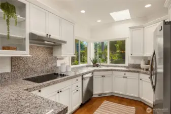 The kitchen looks out over the sunny yard and has updated appliances.