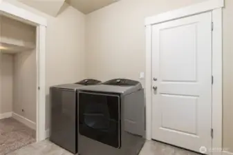 Laundry/mudroom just off the garage. Expansive under-stairs closet to the left. Washer & dryer stay!
