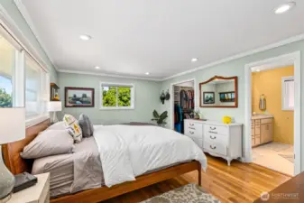Primary Bedroom with walk in closet, three quarter bath with double sinks and walk in shower