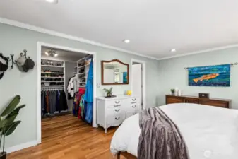 The walk in closet includes custom built ins.